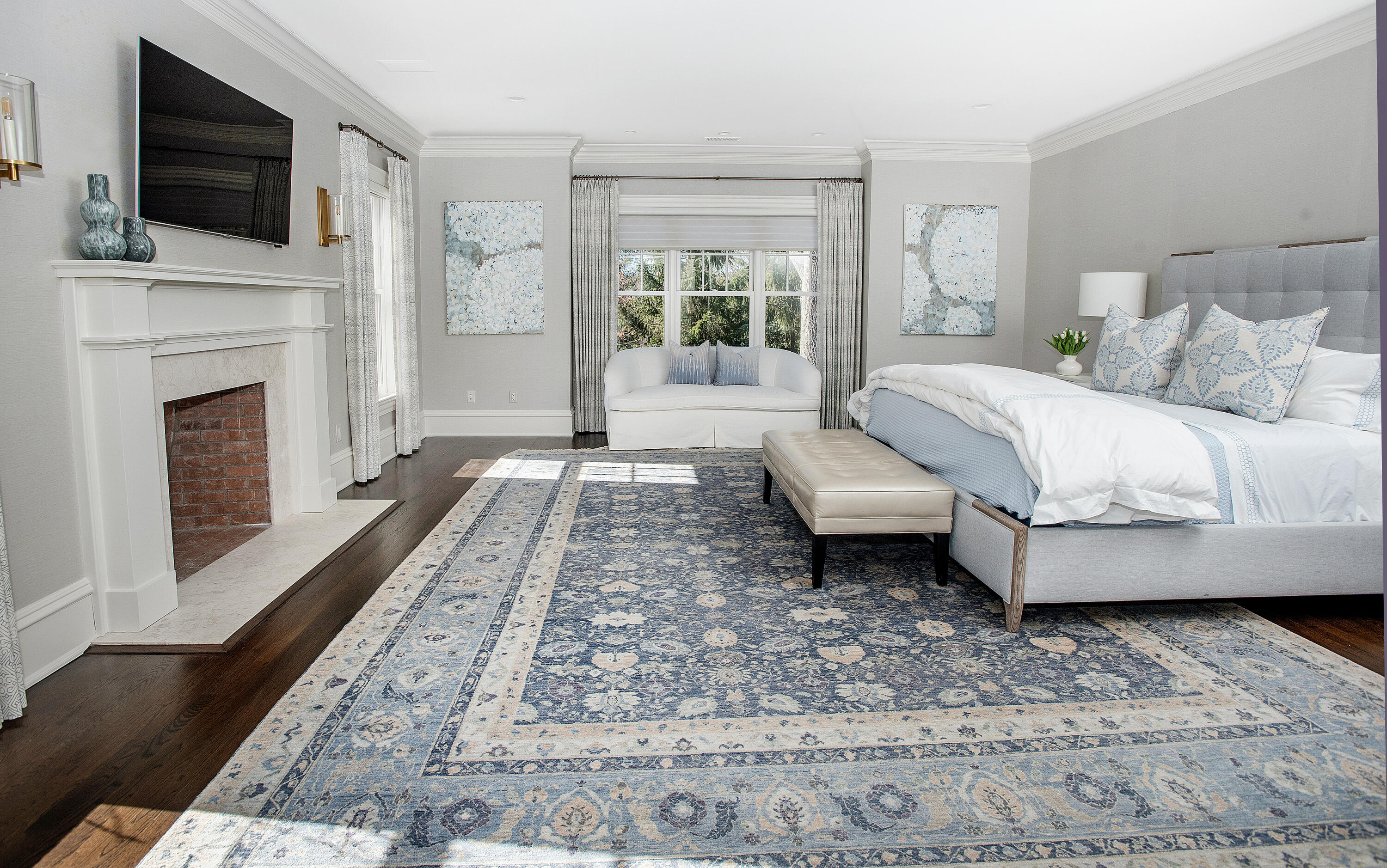 1629 Ponus Ridge Road New Canaan, CT 06840 - Photo 27 of 51 a spacious bedroom with a bed a flat screen tv and a fireplace