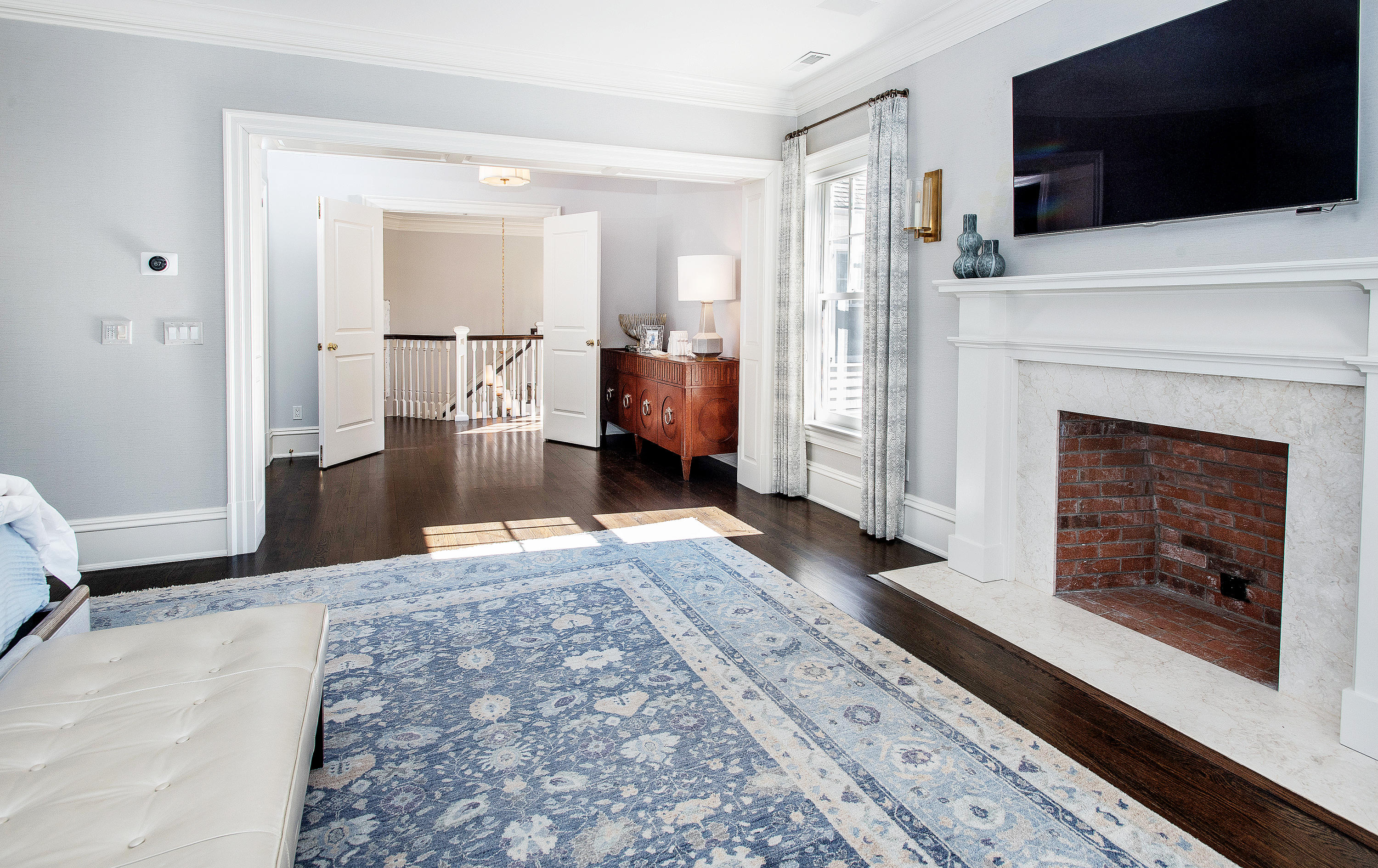 1629 Ponus Ridge Road New Canaan, CT 06840 - Photo 28 of 51 a living room with a fireplace and a flat screen tv