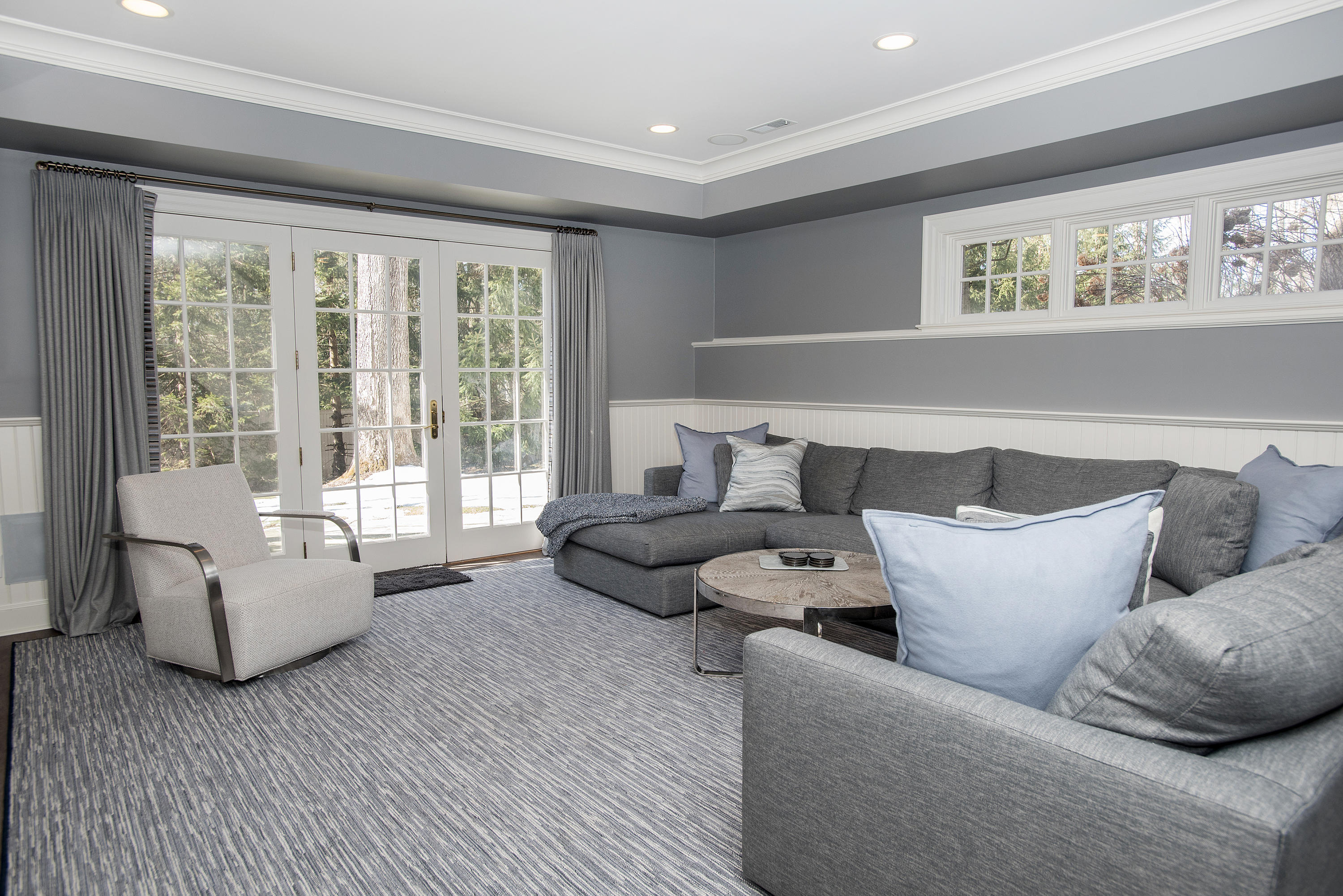 1629 Ponus Ridge Road New Canaan, CT 06840 - Photo 42 of 51 a living room with furniture and large windows