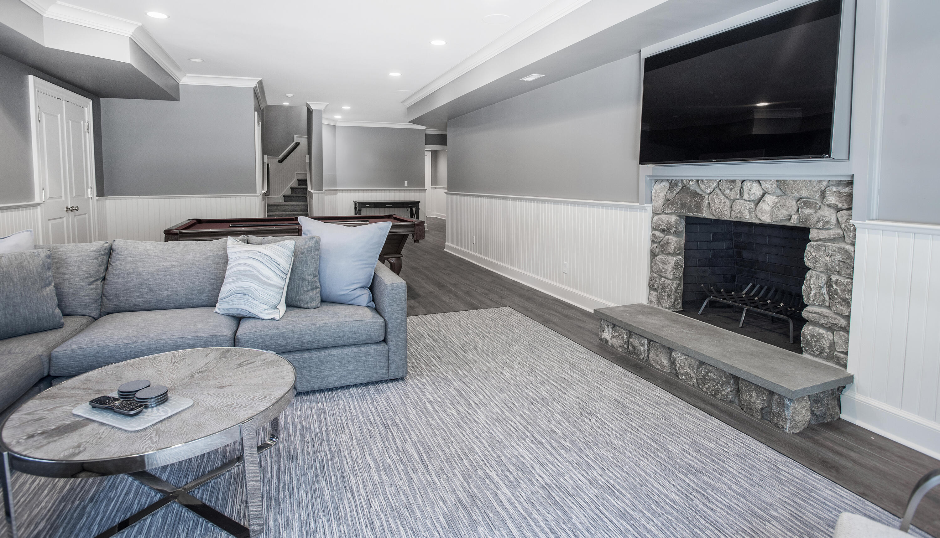 1629 Ponus Ridge Road New Canaan, CT 06840 - Photo 43 of 51 a living room with furniture and a flat screen tv