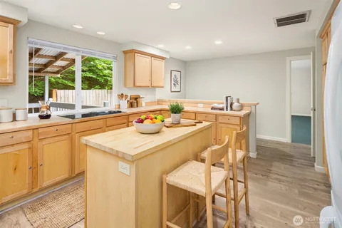 a kitchen with a table chairs sink and cabinets