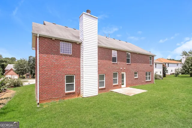 a brick house with a small yard