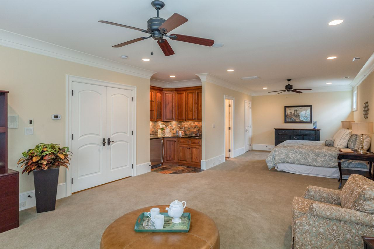 3032 Cone Manor Lane Raleigh, NC 27613 - Photo 19 of 30 In-Laws and special guests will be spoiled during their stay as this retreat offers a mini-kitchen, sitting area, walk-in closet, and bath with walk-in shower and tile surround. It also features a designated HVAC thermostat for your guest's comfort. Luxurious In-Law/Guest Suite - Bedroom #2