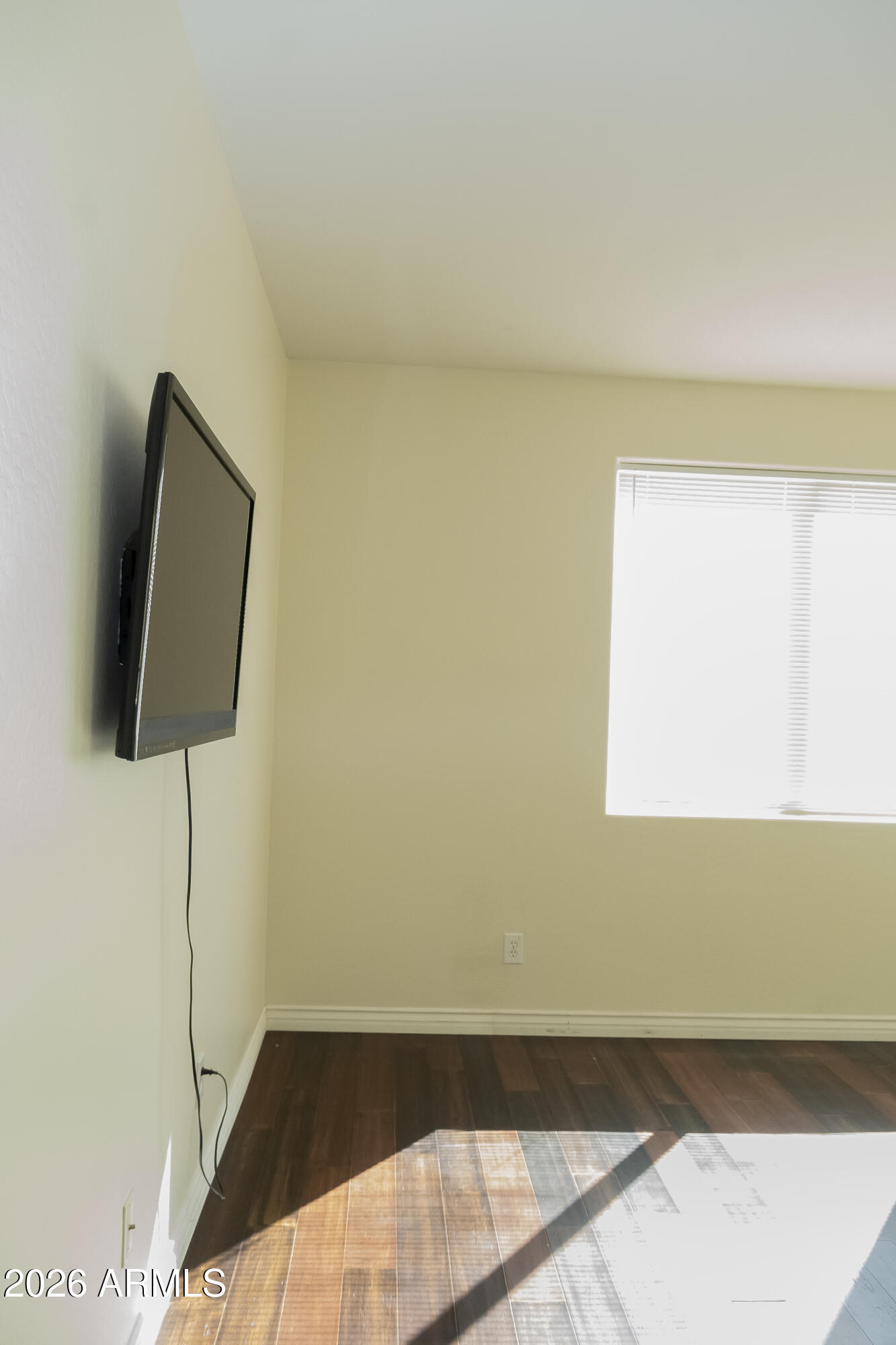 16045 West Almeria Road Goodyear, AZ 85395 - Photo 18 of 31 a view of a room with wooden floor and cabinet