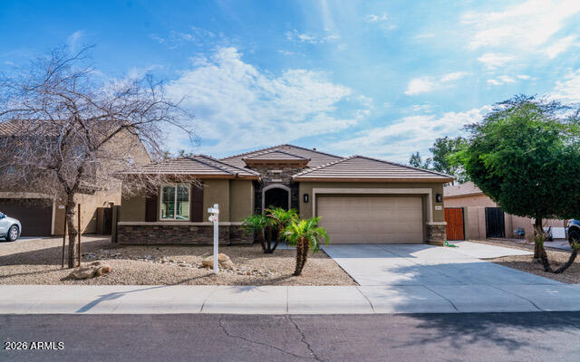 16045 West Almeria Road Goodyear, AZ 85395 - Photo 2 of 31 a front view of a house with garden
