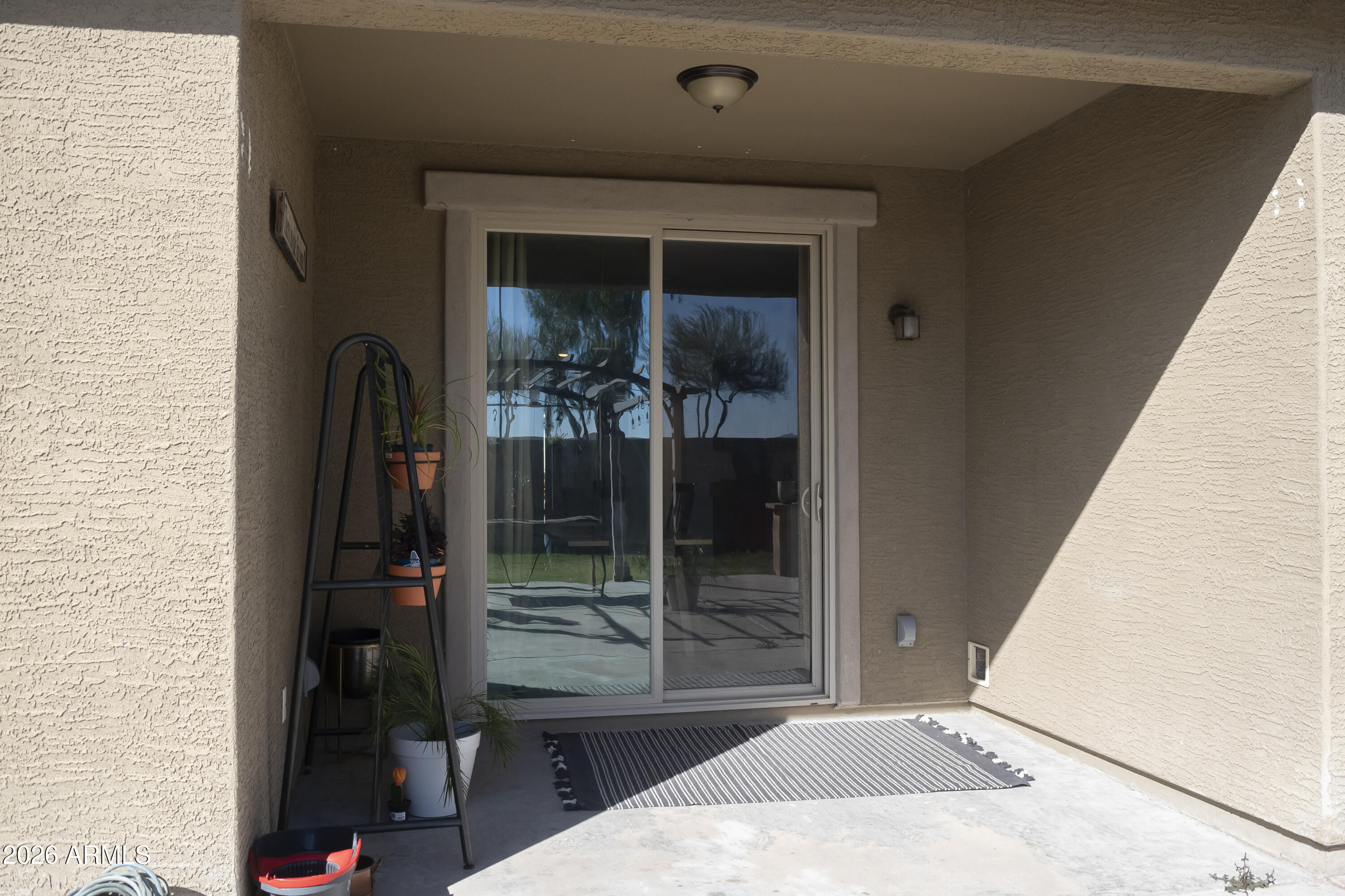 16045 West Almeria Road Goodyear, AZ 85395 - Photo 30 of 31 a bedroom with a bed and a mirror