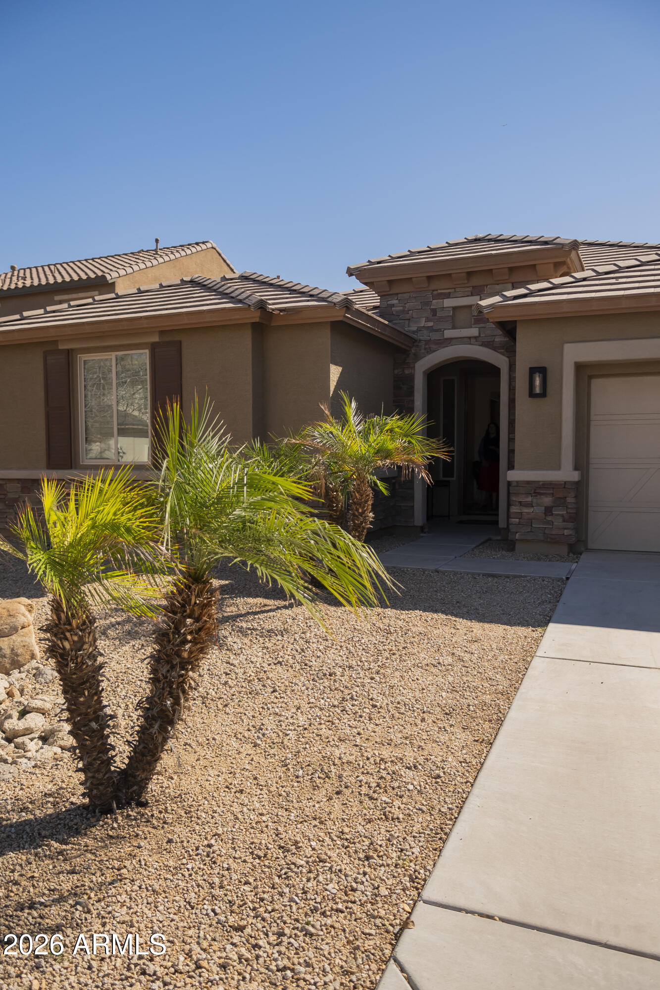 16045 West Almeria Road Goodyear, AZ 85395 - Photo 3 of 31 a view of a house with a patio