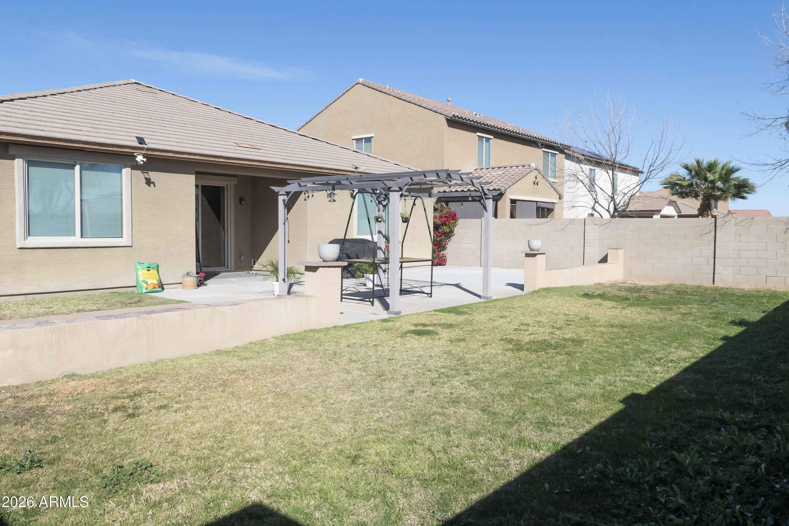 16045 West Almeria Road Goodyear, AZ 85395 - Photo 31 of 31 a view of a patio with table and chairs under an umbrella
