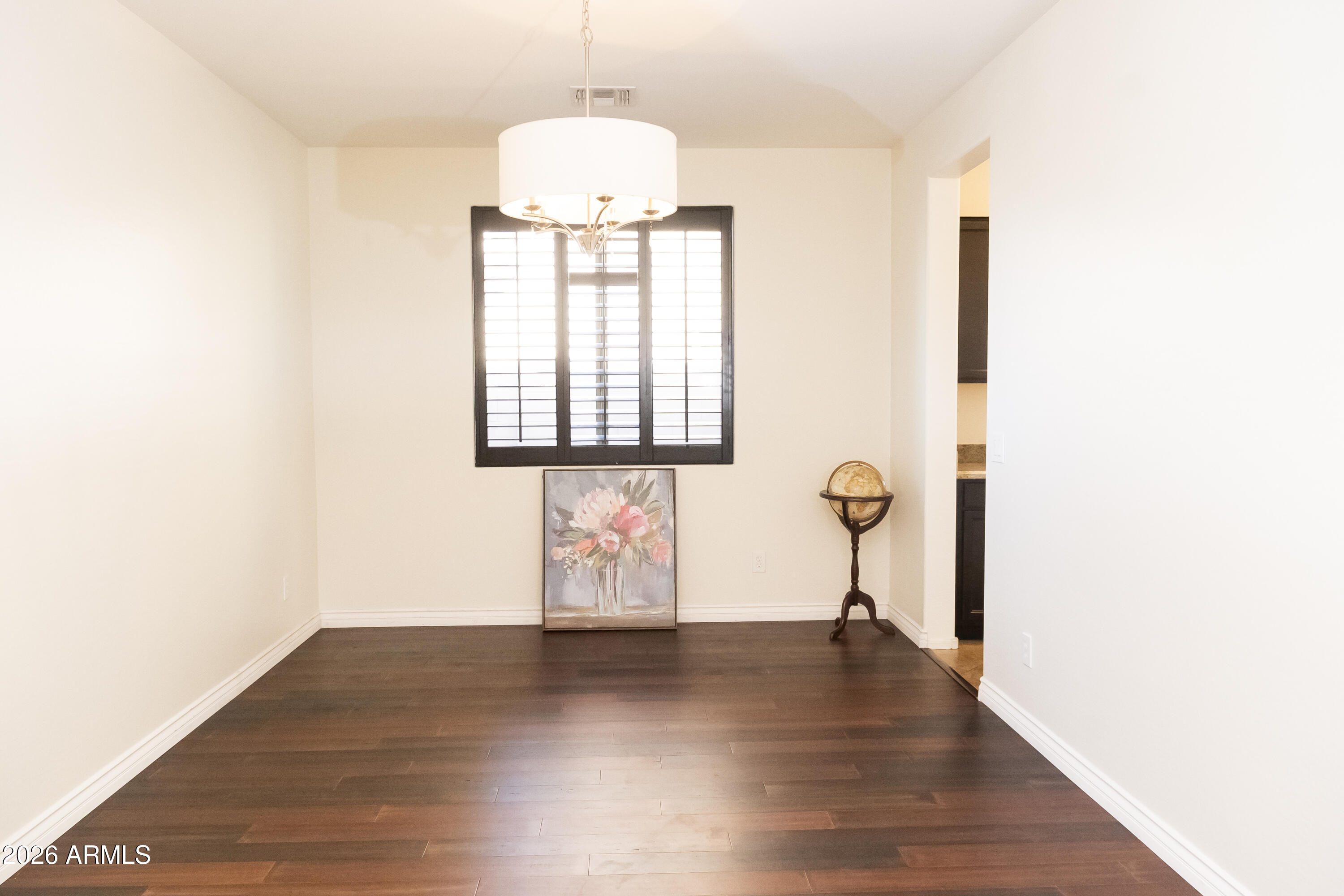 16045 West Almeria Road Goodyear, AZ 85395 - Photo 6 of 31 a view of a room with wooden floor and entryway