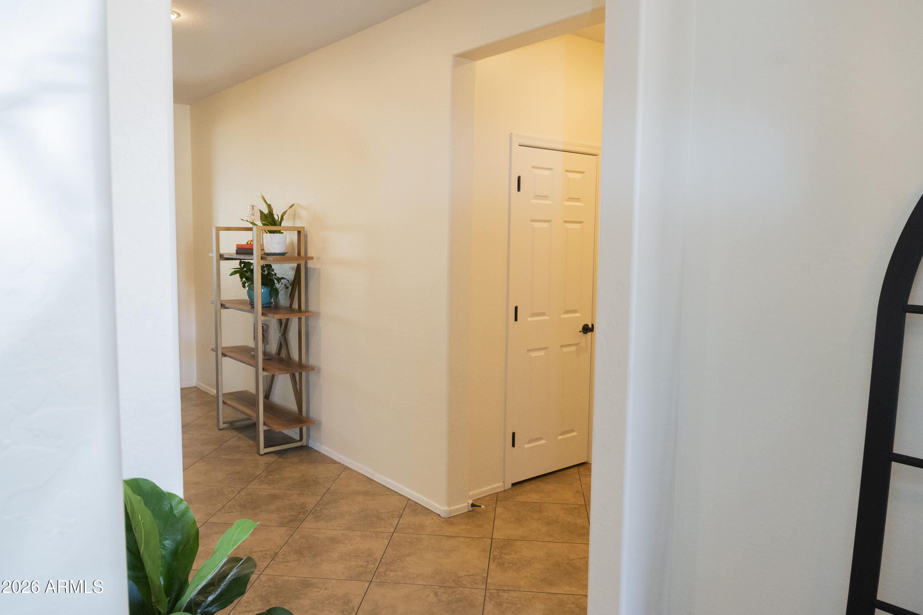 16045 West Almeria Road Goodyear, AZ 85395 - Photo 7 of 31 a view of a hallway with wooden floor and a closet