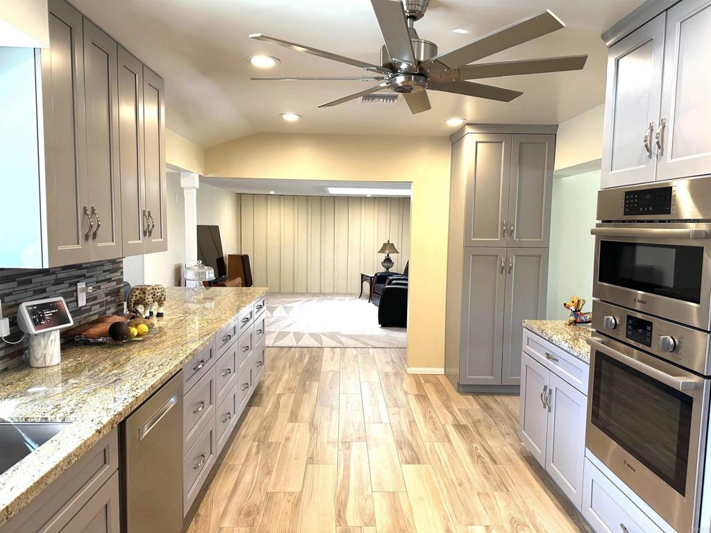 1001 Riverview Drive Fallbrook, CA 92028 - Photo 4 of 36 a large kitchen with a stove a sink dishwasher a microwave oven with cabinets and wooden floor