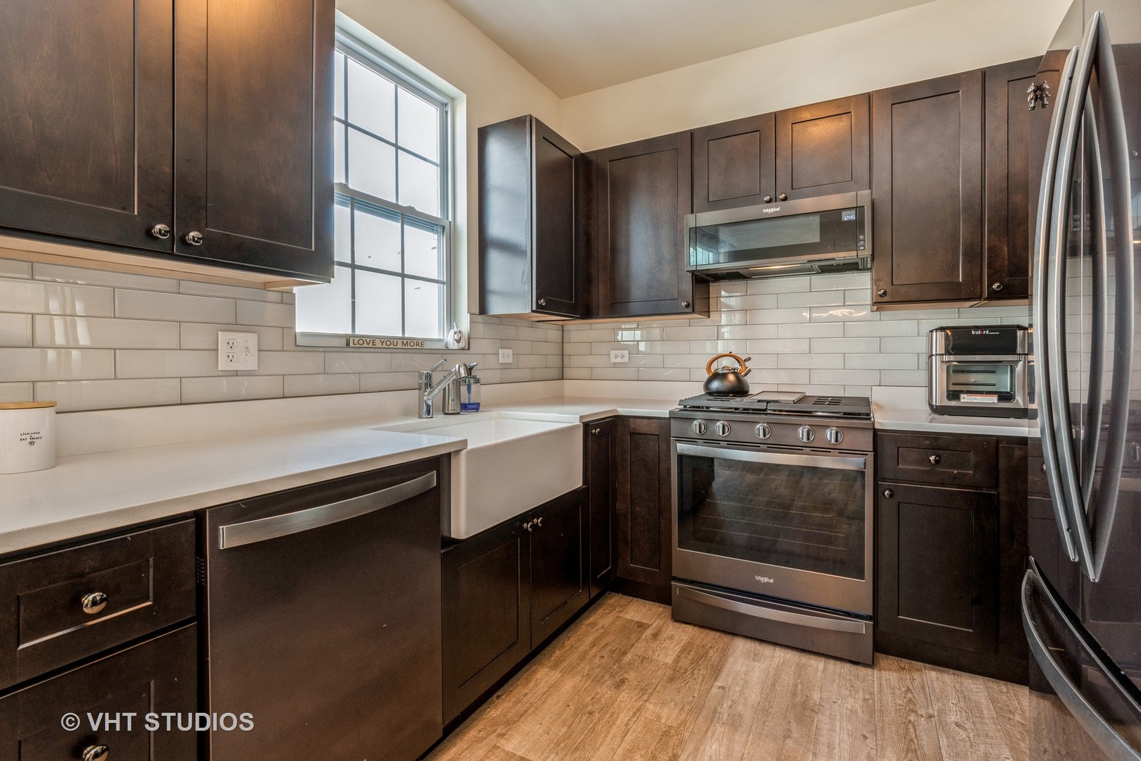 285 Timber Ridge Court Joliet, IL 60431 - Photo 7 of 21 a kitchen with stainless steel appliances wooden cabinets and a stove top oven