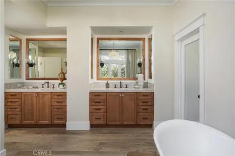 a white bath tub sitting in a bathroom next to a window