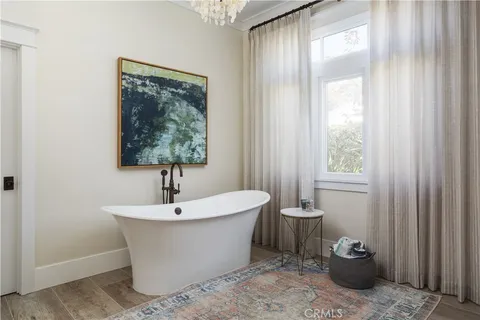a bathroom with a tub shower and window
