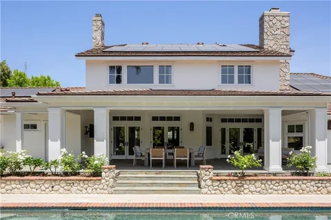 a front view of a house with swimming pool having outdoor seating