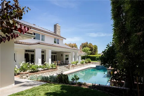 a view of swimming pool with outdoor seating and plants