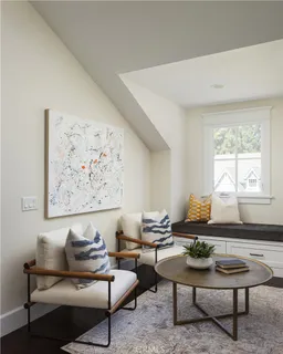 a bed sitting in a spacious bedroom next to a window