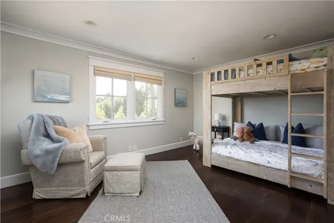 a bedroom with furniture and wooden floor