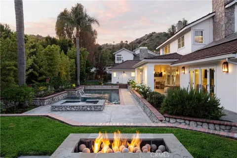 a view of a backyard with plants and a patio