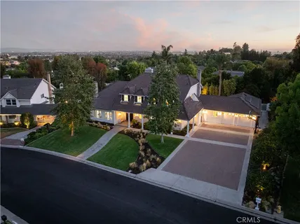 an aerial view of residential houses with outdoor space and street view