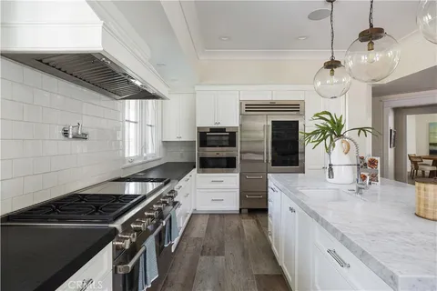 a kitchen with stove and cabinets