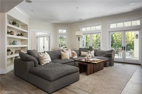 a living room with furniture and large windows