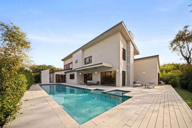 a view of a patio with dining table and chairs with wooden floor and fence