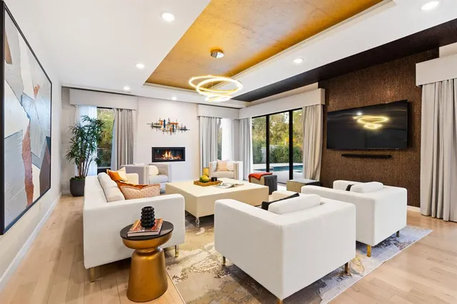 a living room with fireplace furniture and a flat screen tv