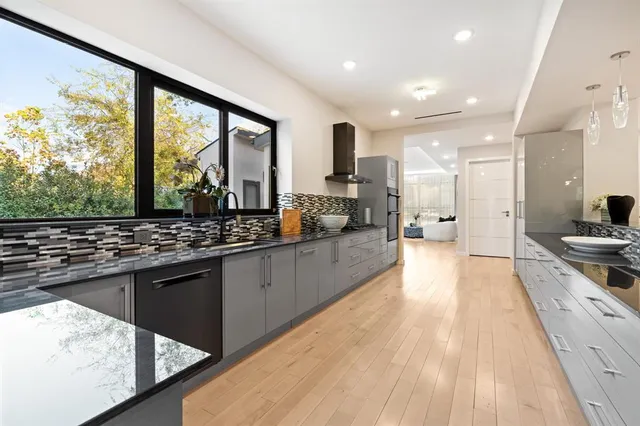 a kitchen with stainless steel appliances kitchen island granite countertop a stove and a sink
