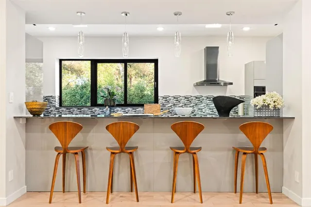a kitchen with stainless steel appliances granite countertop a sink and a refrigerator