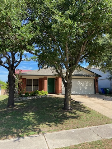 17616 Tobermory Drive Pflugerville, TX 78660 - Photo 1 of 14 Mature trees frame this traditional brick residence, offering pleasant curb appeal and a spacious driveway.