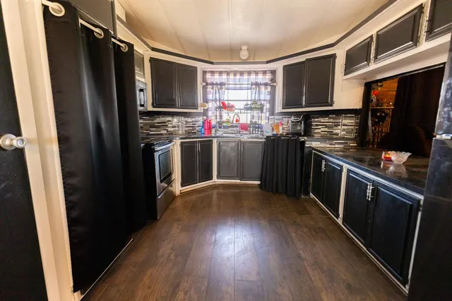 a kitchen with stainless steel appliances granite countertop a sink and cabinets