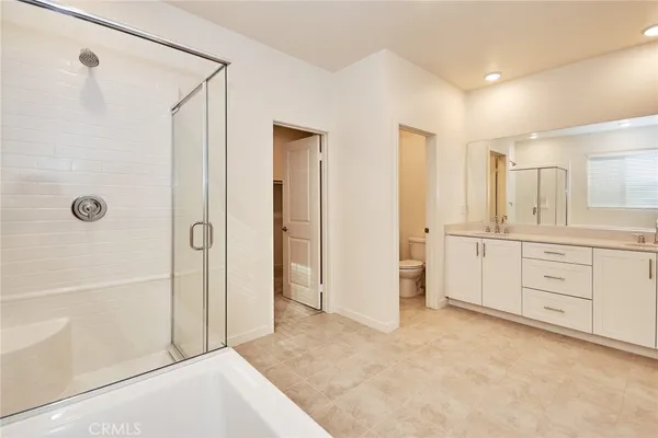 a bathroom with a granite countertop sink a mirror a shower and vanity