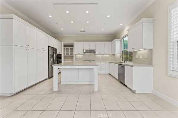 a kitchen with white cabinets and white appliances