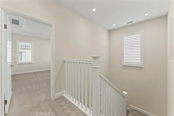 a view of a hallway with windows