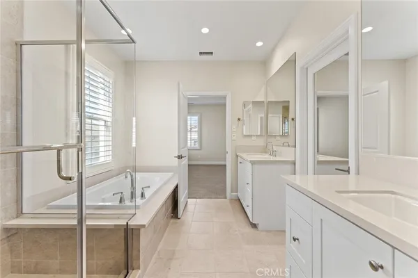 a bathroom with a granite countertop sink mirror and a bathtub