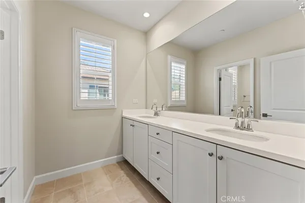 a bathroom with 2 sink tub and a mirror