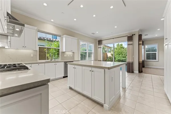 a kitchen with granite countertop white cabinets and appliances