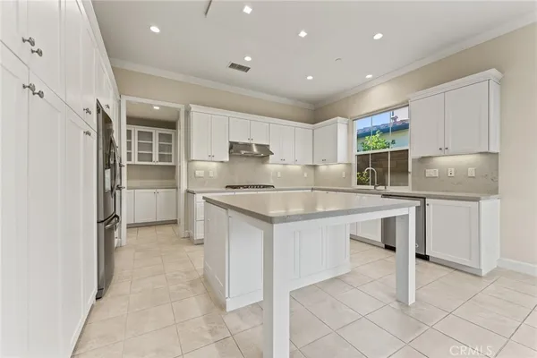 a kitchen with granite countertop a sink appliances cabinets and counter space
