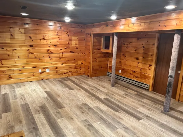 a view of a room with wooden floor