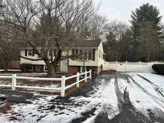 a view of a house with snow on the road