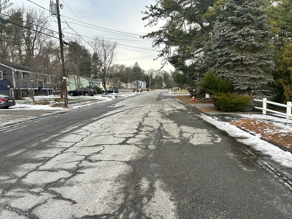 a view of road with a houses