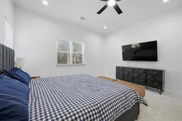 a bedroom with a bed dresser and a window