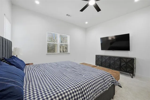 a bedroom with a bed dresser and a window