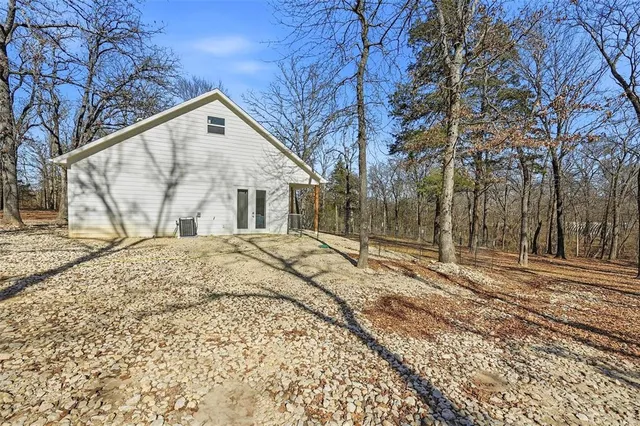 a view of a house with a yard covered with snow