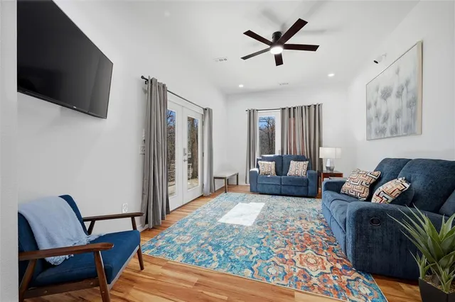 a living room with furniture and wooden floor
