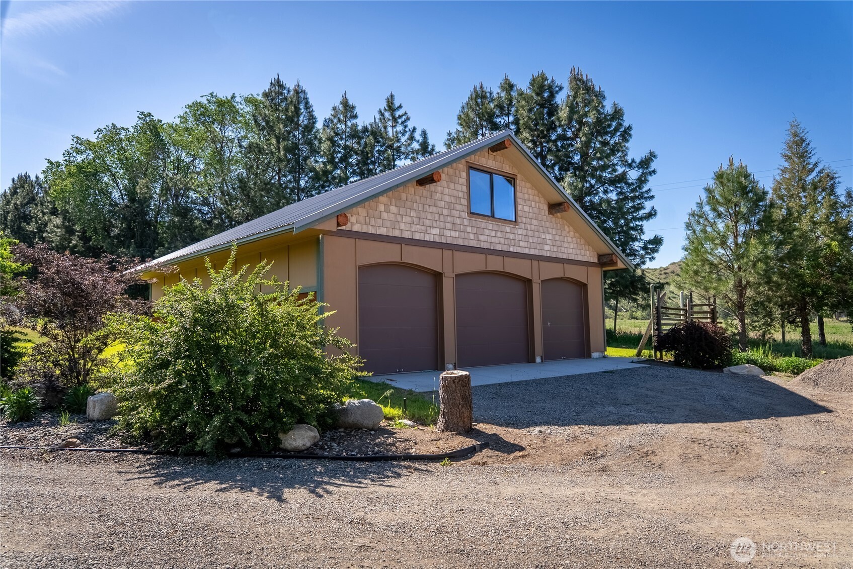 2621 Highway 153 Twisp, WA 98856 - Photo 36 of 40 a front view of a house with a yard and garage