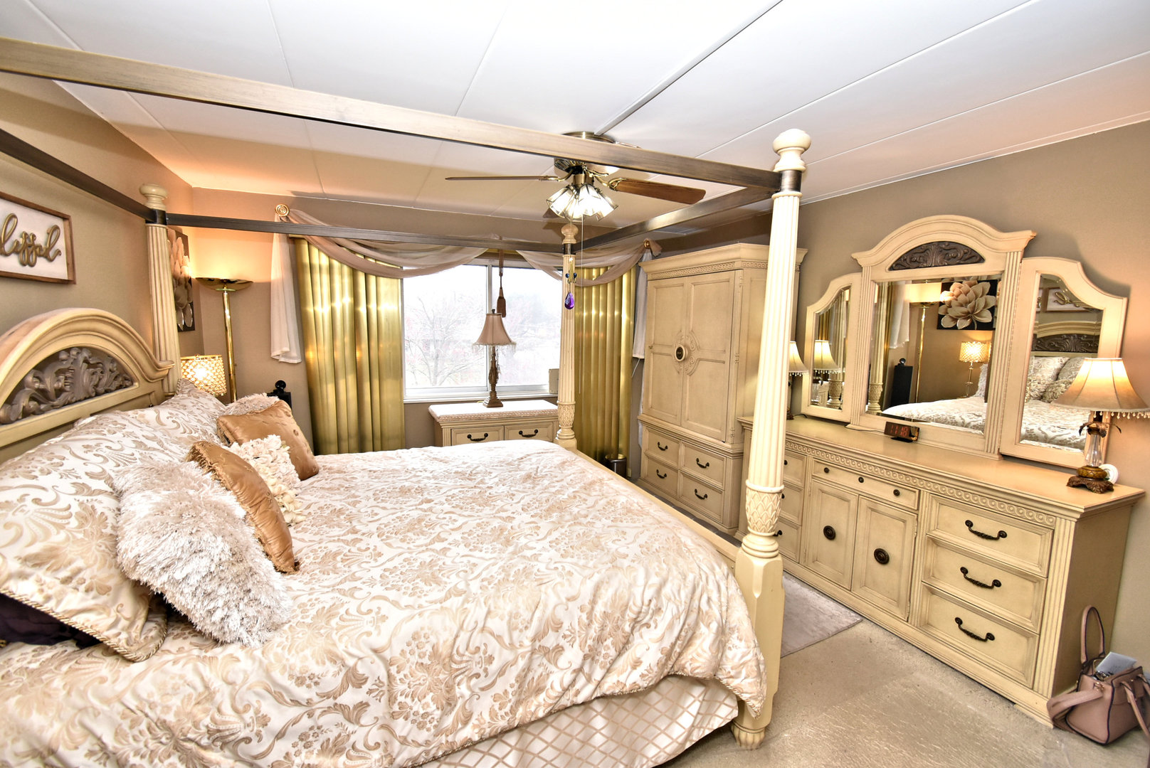 18855 Burnham Avenue, Unit 234 Lansing, IL 60438 - Photo 12 of 25 a bedroom with a bed a dresser and chandelier