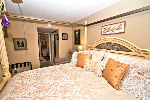 a bedroom with a large bed and a couch