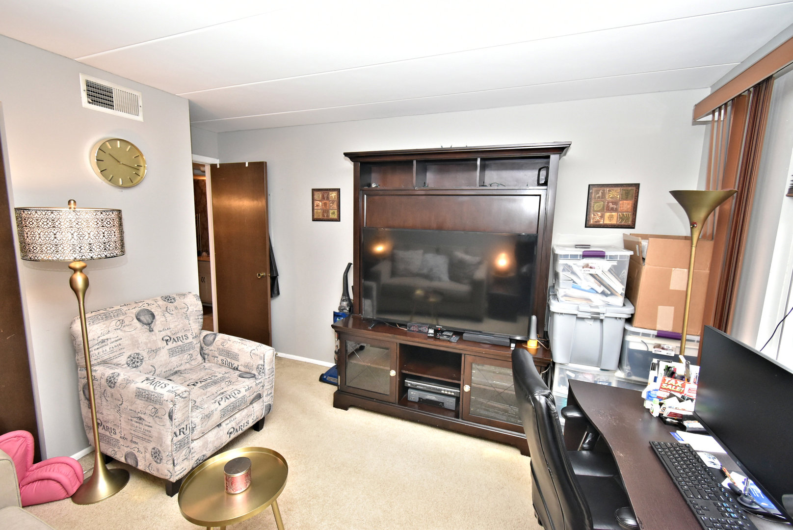 18855 Burnham Avenue, Unit 234 Lansing, IL 60438 - Photo 17 of 25 a living room with furniture and a flat screen tv